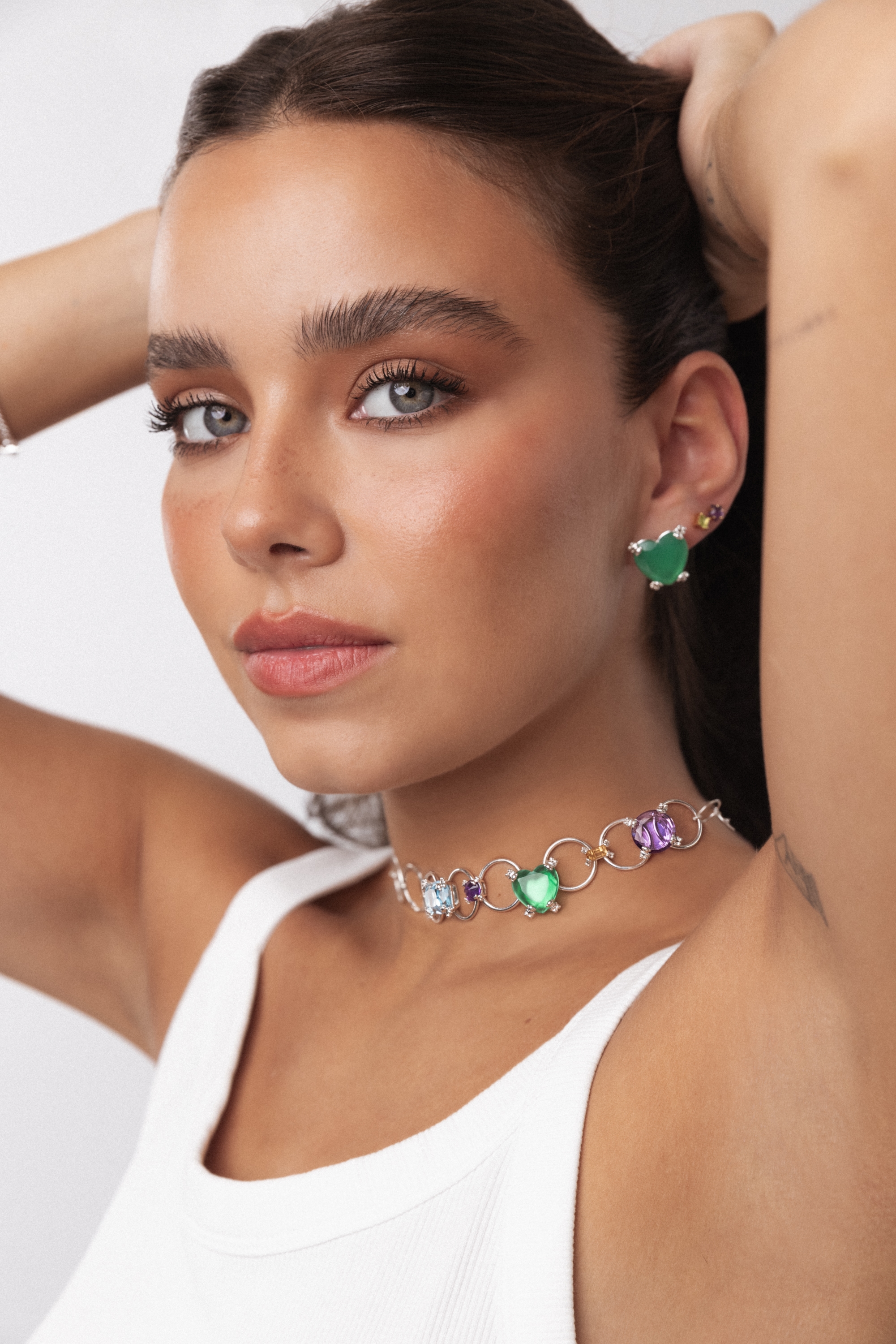 A girl with long hair, red lipstick and a necklace of green rings