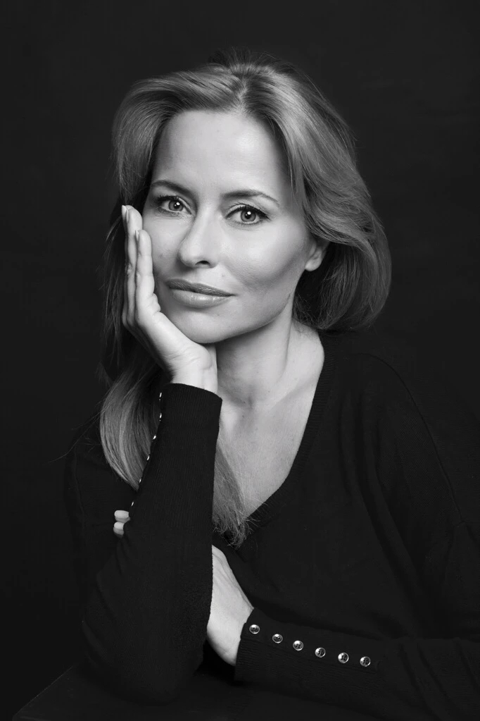 Actress Carla Salgueiro in a balck and white classic portrait. shoot in a black background with Carla wearing a black shirt