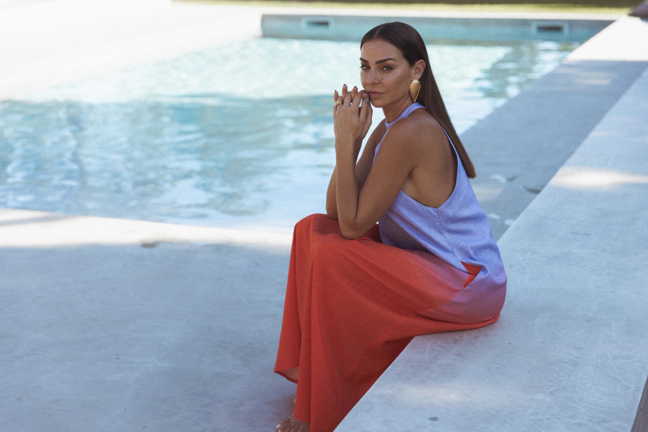 Vanessa Martins brings summer sophistication in a pink-orange gradient dress, posing for SIENNA INSPO's summer fashion photoshoot.